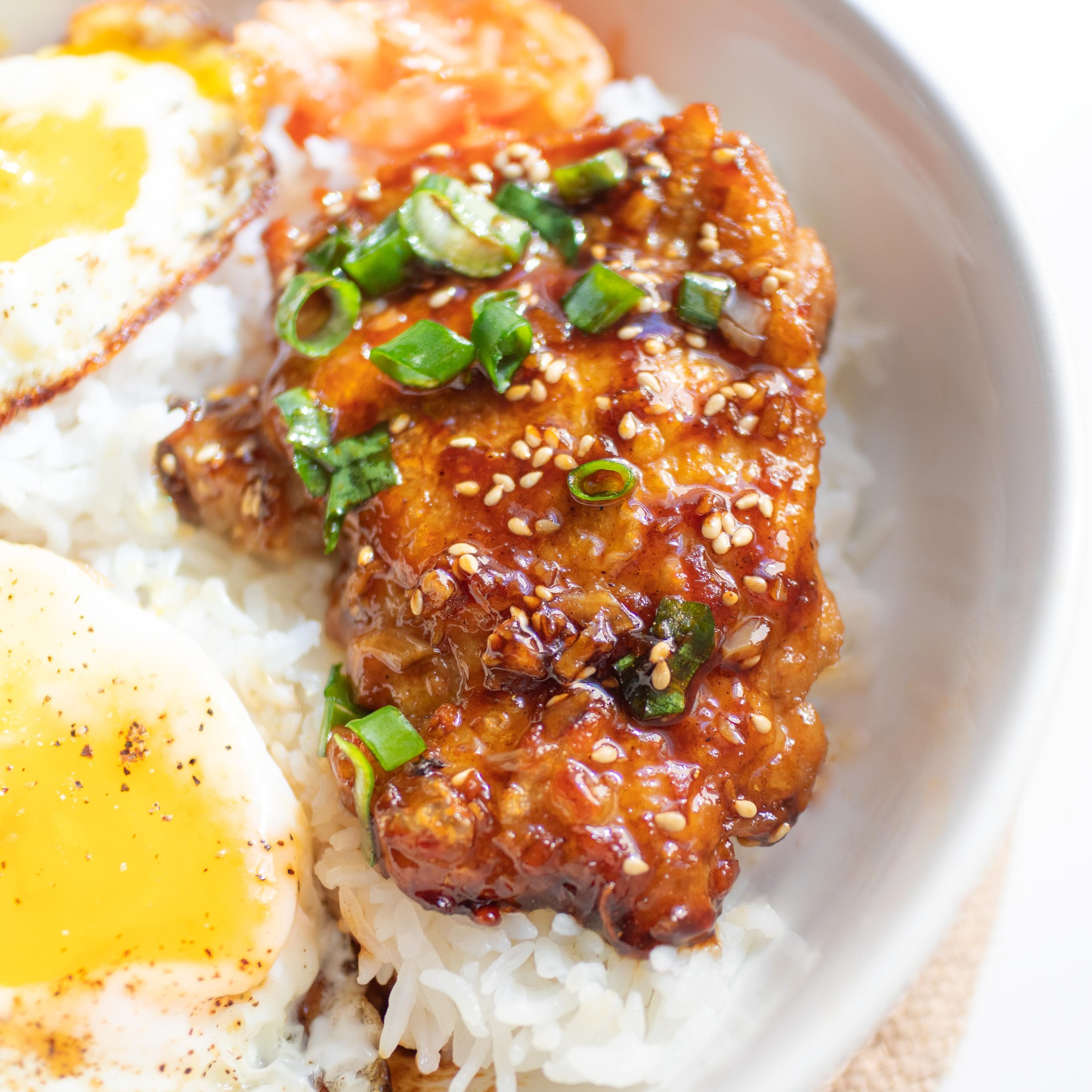 Easy pan-fried soy sauce glazed chicken served with steamed white rice, kimchi, and fried eggs