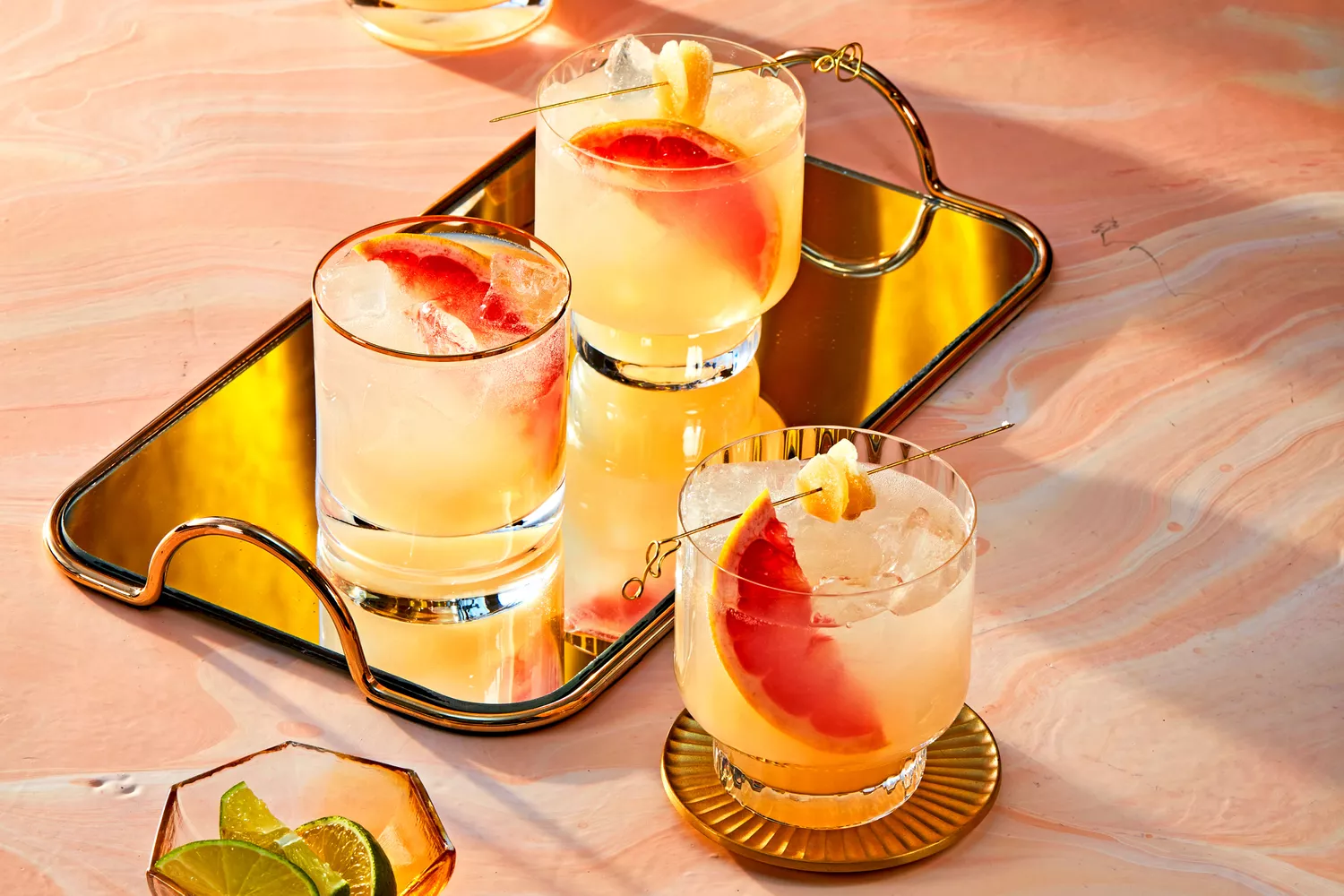 Southern Living Ginger Rogers Cocktail in glasses to serve garnished with fresh grapefruit and ginger