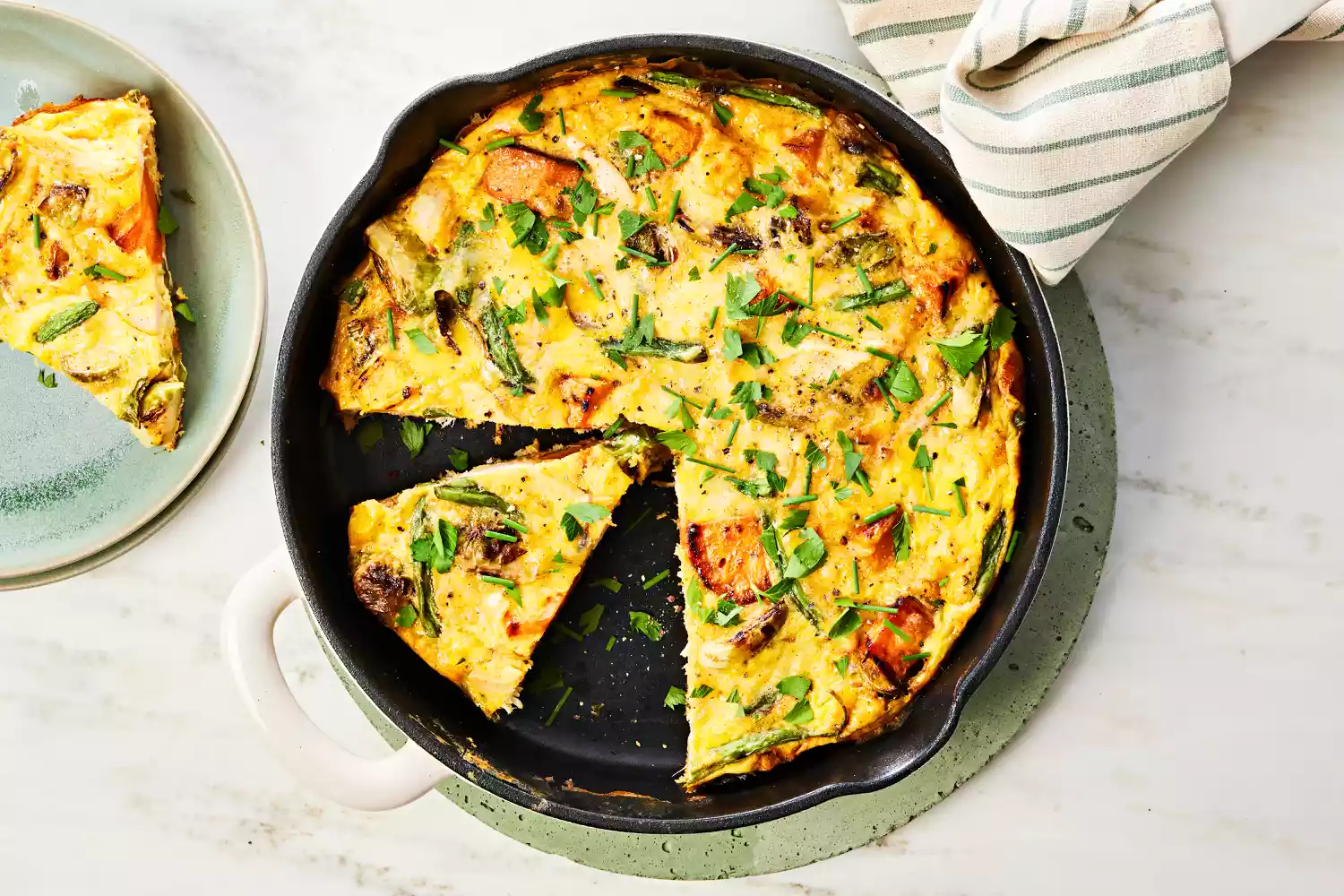 Southern Living Turkey Frittata in the pan sliced and ready to serve