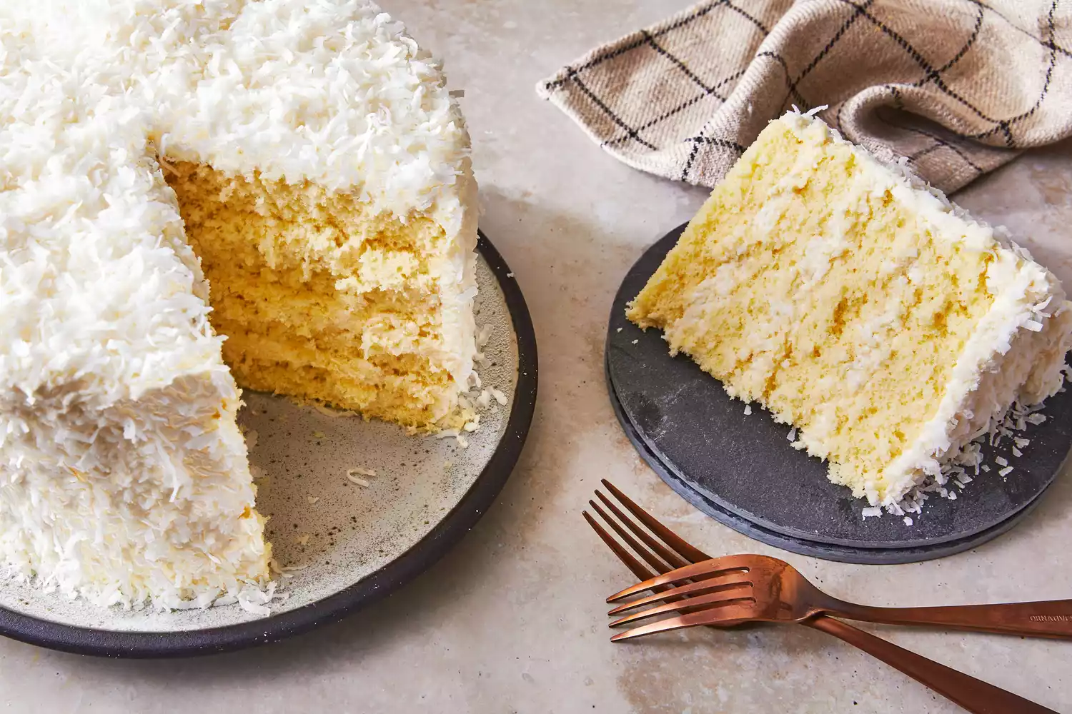 Southern Living Coconut Chiffon Cake on a platter with a serving cut out beside it