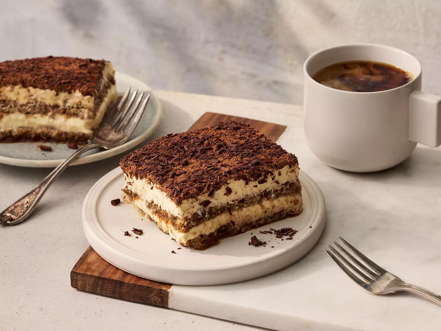 Southern Living Tiramisu two servings on plates with a small cup of coffee