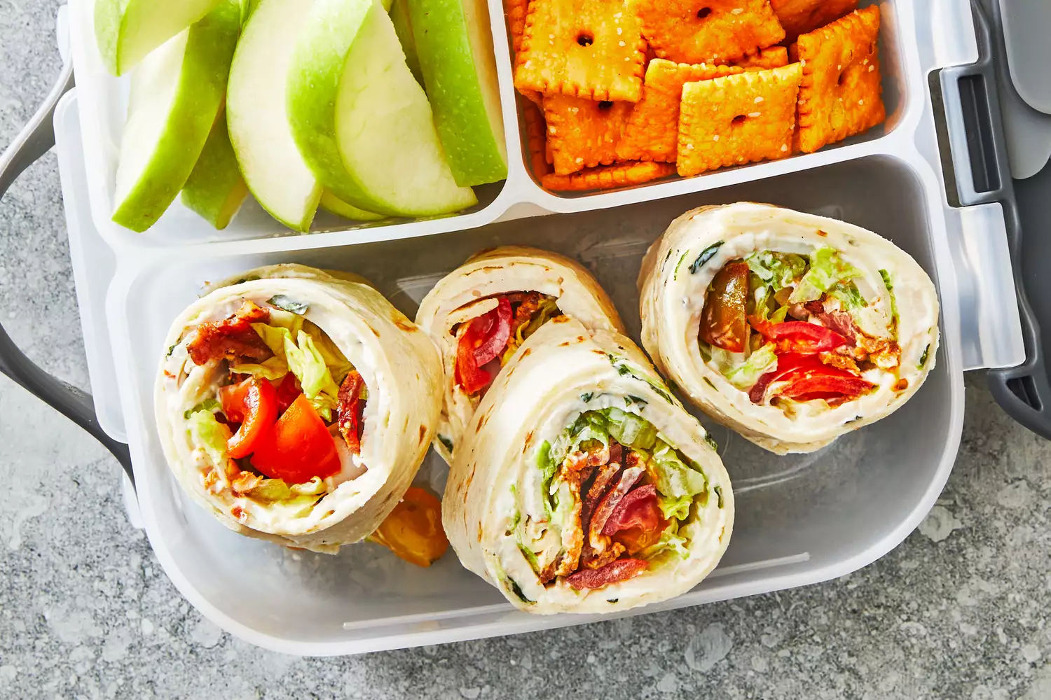 Southern Living Turkey BLT Pinwheels in a lunchbox to serve